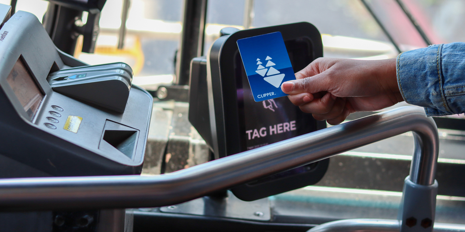 Person using Clipper card to tap on reader